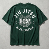 Dark green oversize Jiu Jitsu BJJ lifestyle t-shirt with back graphic of a snake coiled around Breaking Bone text.