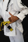 Close-up of Kids White BJJ Gi with professional embroidery, reinforced stitching, and a shaka hand gesture.